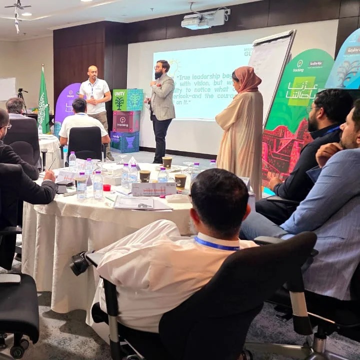 A speaker presenting to attendees at a professional leadership development session